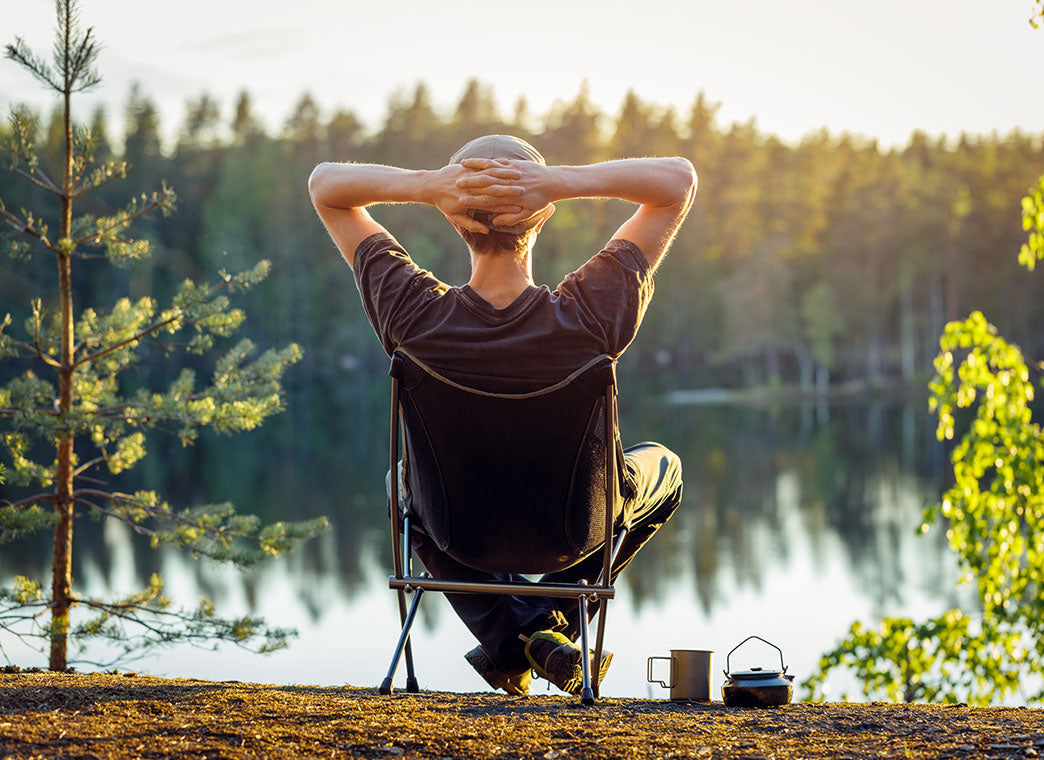 Man Siting Early Morning By a Lake Enjoying nature - Healthy Daily Habits That Support HPA Axis Balance And Stress Resilience